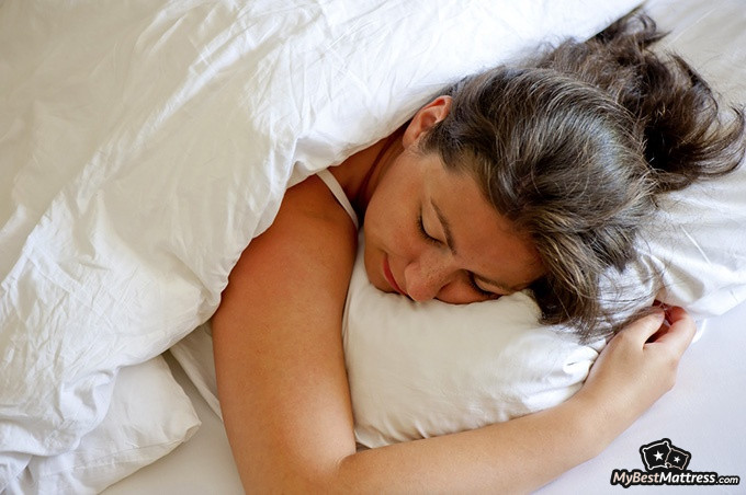 Sleeping on stomach: a woman sleeping on her stomach. Sleeping on stomach: a woman sleeping on her stomach.